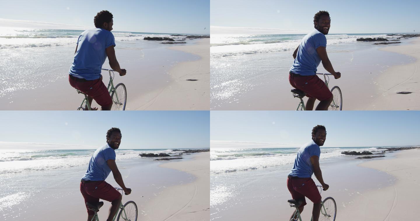 非洲裔美国人微笑和骑自行车在海滩上