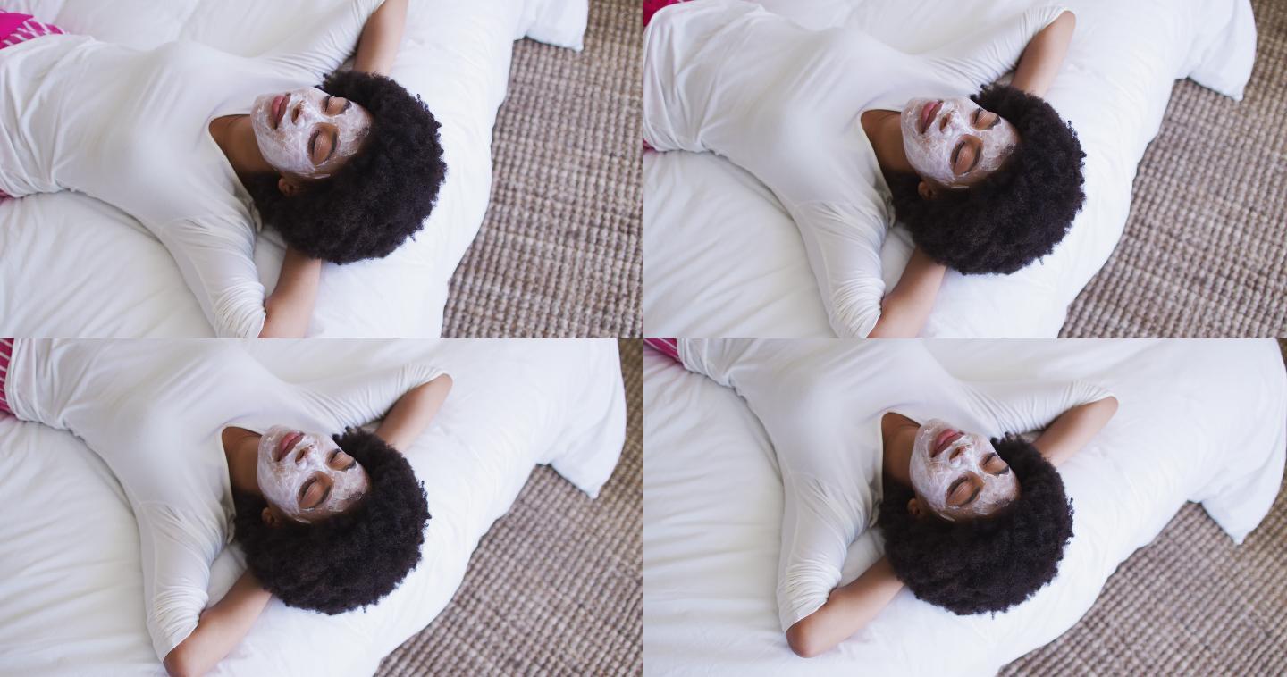非裔美国妇女戴着口罩躺在床上
