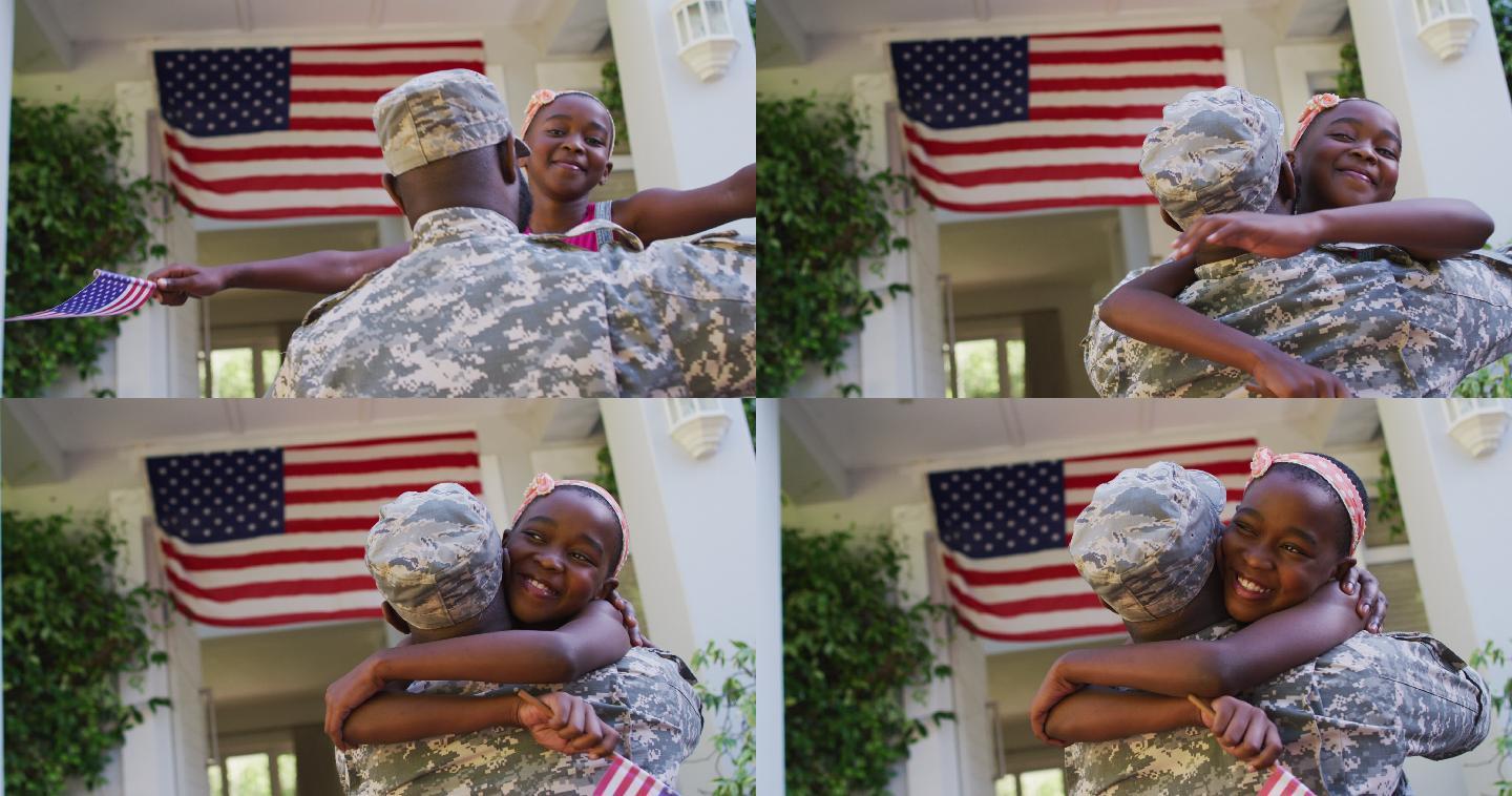 非裔美国士兵父亲在美国国旗前拥抱微笑的女儿
