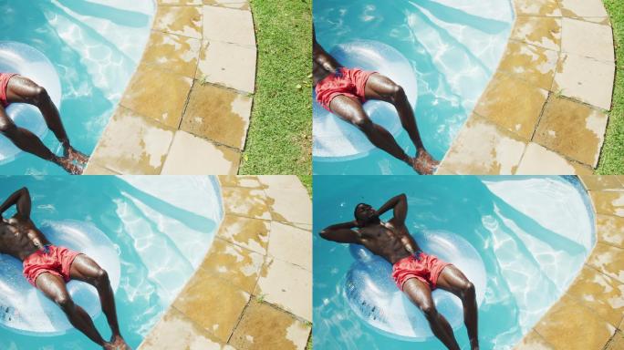 英俊的非裔美国人躺在充气游泳池日光浴