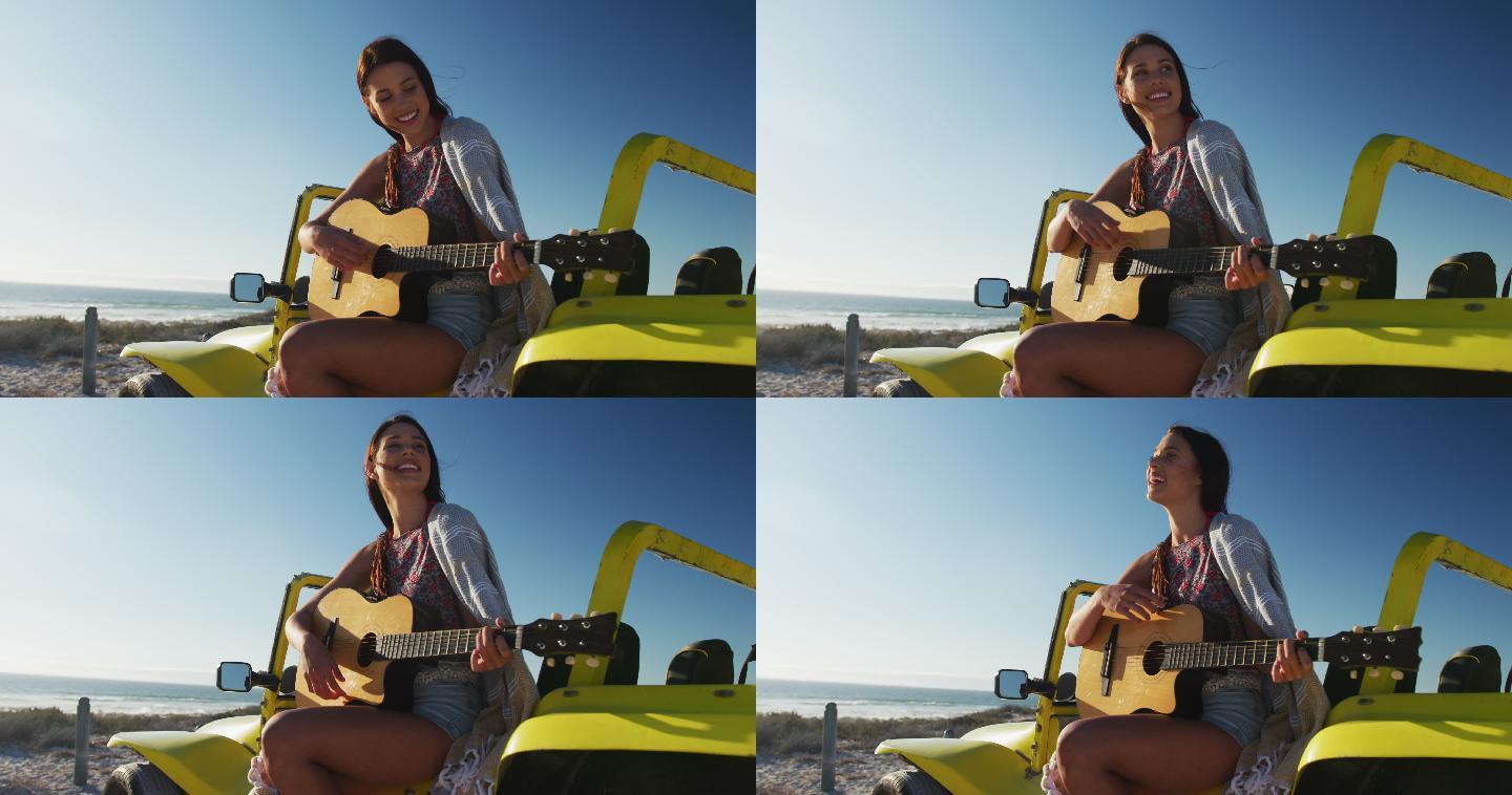 快乐的白人女人坐在沙滩车在海边弹吉他