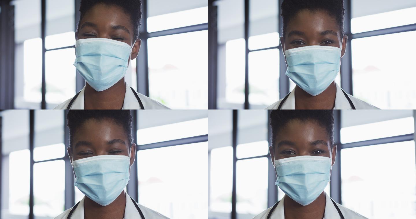 非裔美国女医生的肖像戴着面具看着照相机