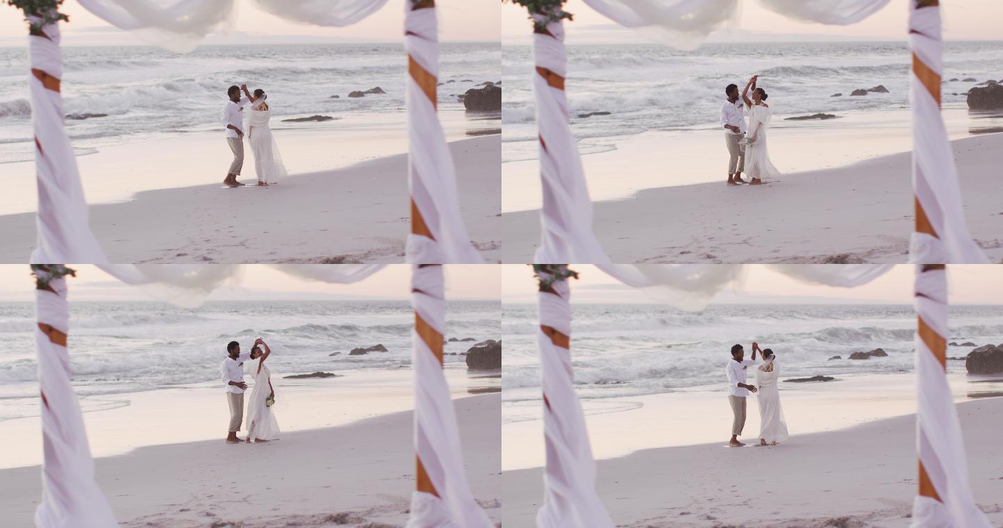 相爱的非裔美国人结婚，在海滩上跳舞