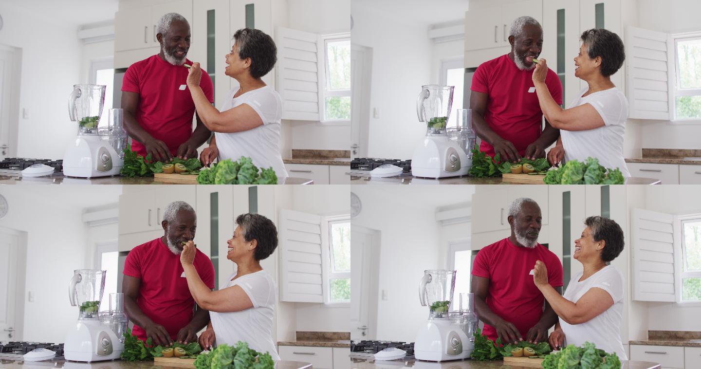 高级非洲裔美国男女在家里准备水果和蔬菜保健饮料