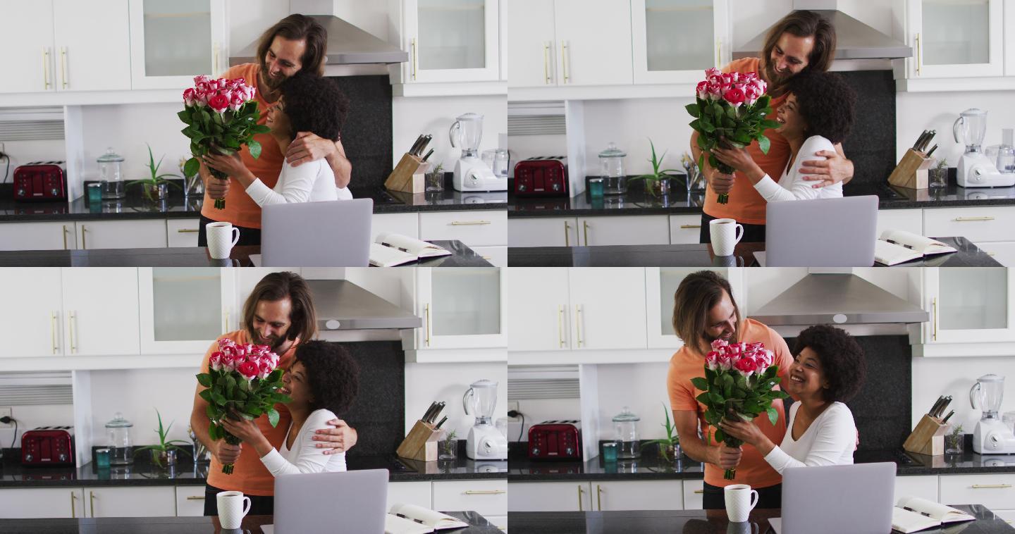 一名白人男子在厨房里给他的妻子一束花