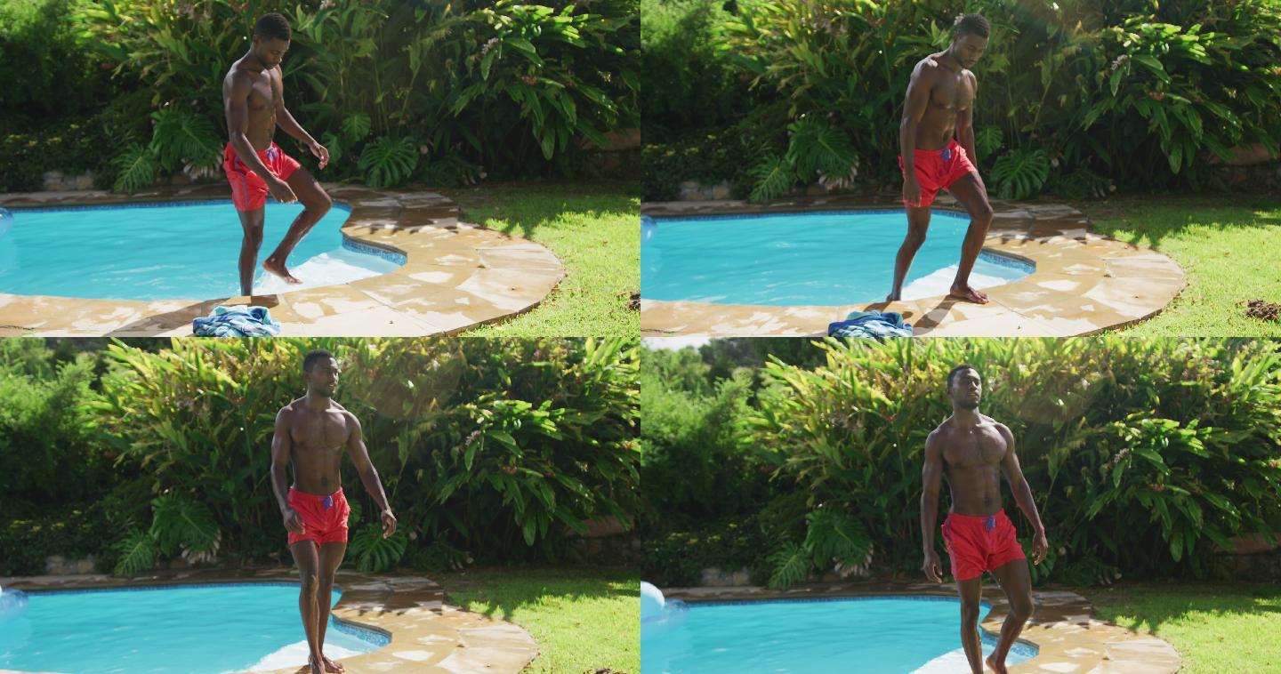 英俊的非裔美国人走出游泳池在阳光灿烂的花园