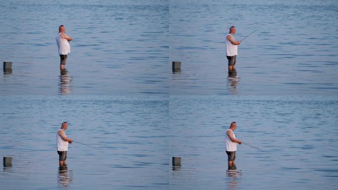 站在湖里钓鱼的人