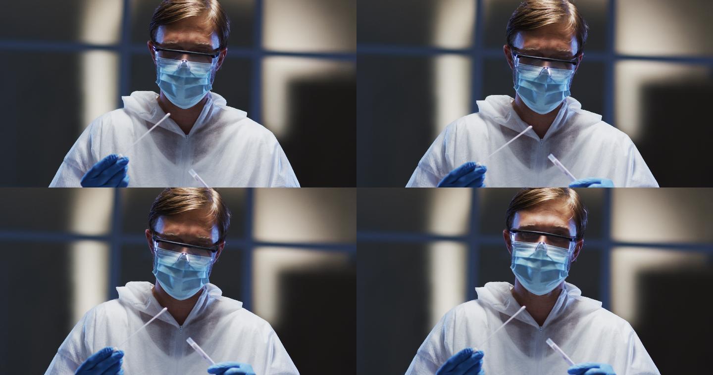 穿着防护服戴口罩的白人男性医务工作者正在进行病人拭子试验