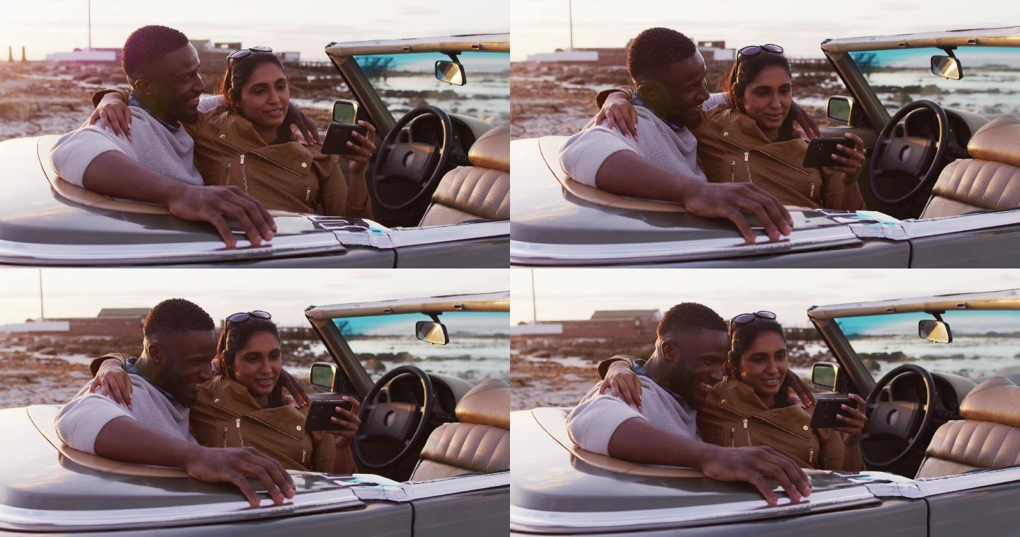 一对非洲裔美国夫妇坐在路上的敞篷车里自拍