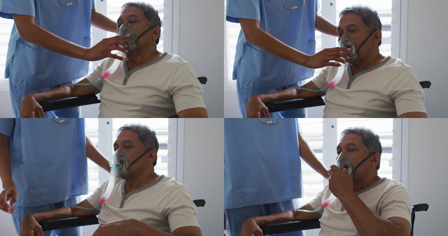 混血女医生在家中协助老年男子使用呼吸机
