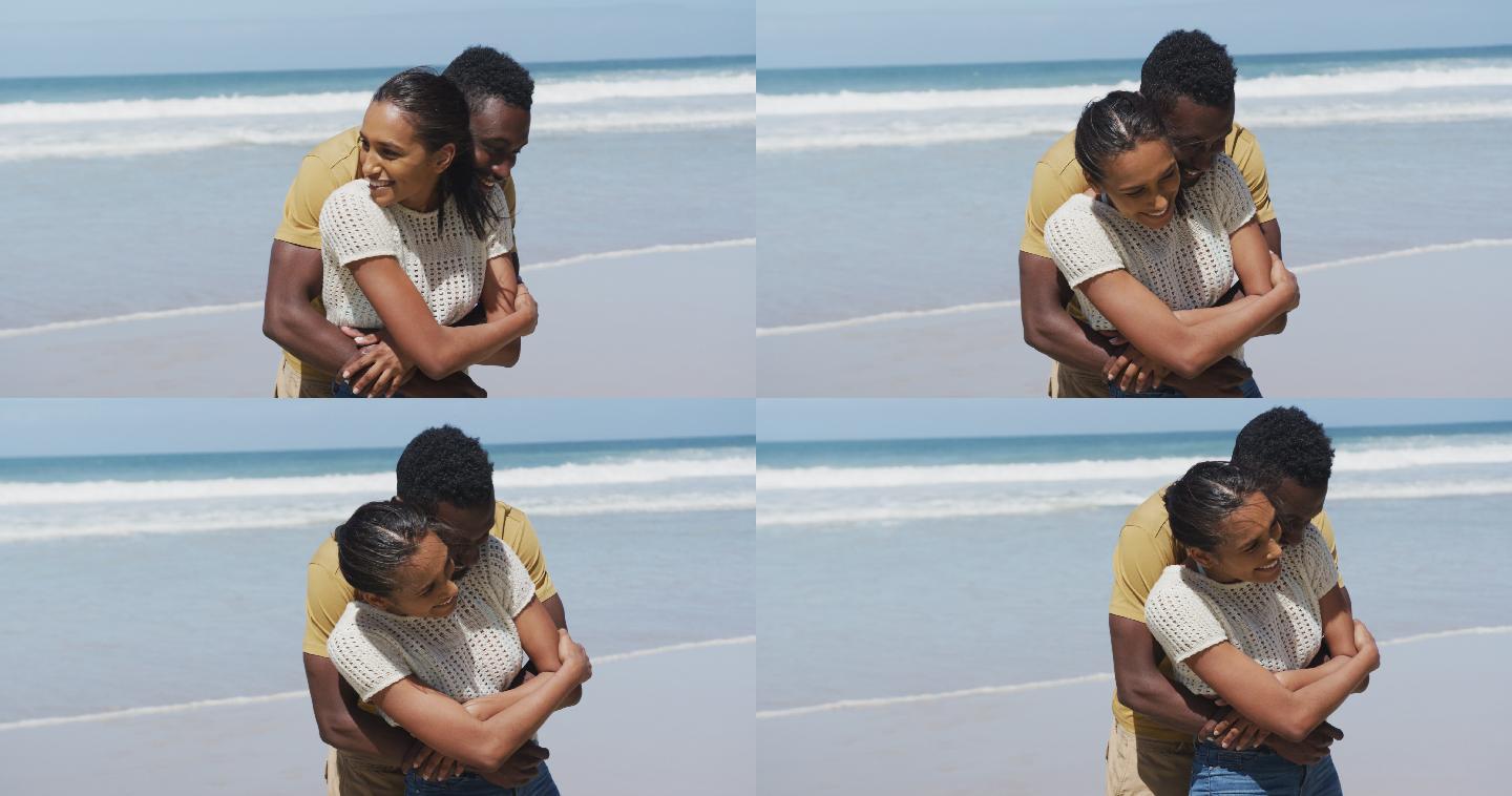 快乐的非裔美国情侣在海滩上拥抱彼此