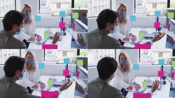 不同的商业同事戴着口罩在办公室里用电脑聊天