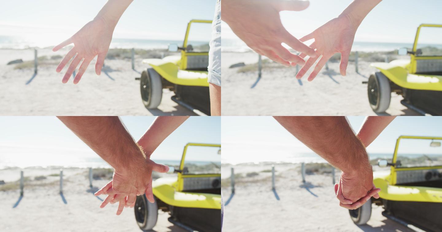 白种夫妇站在海边的沙滩车牵着手