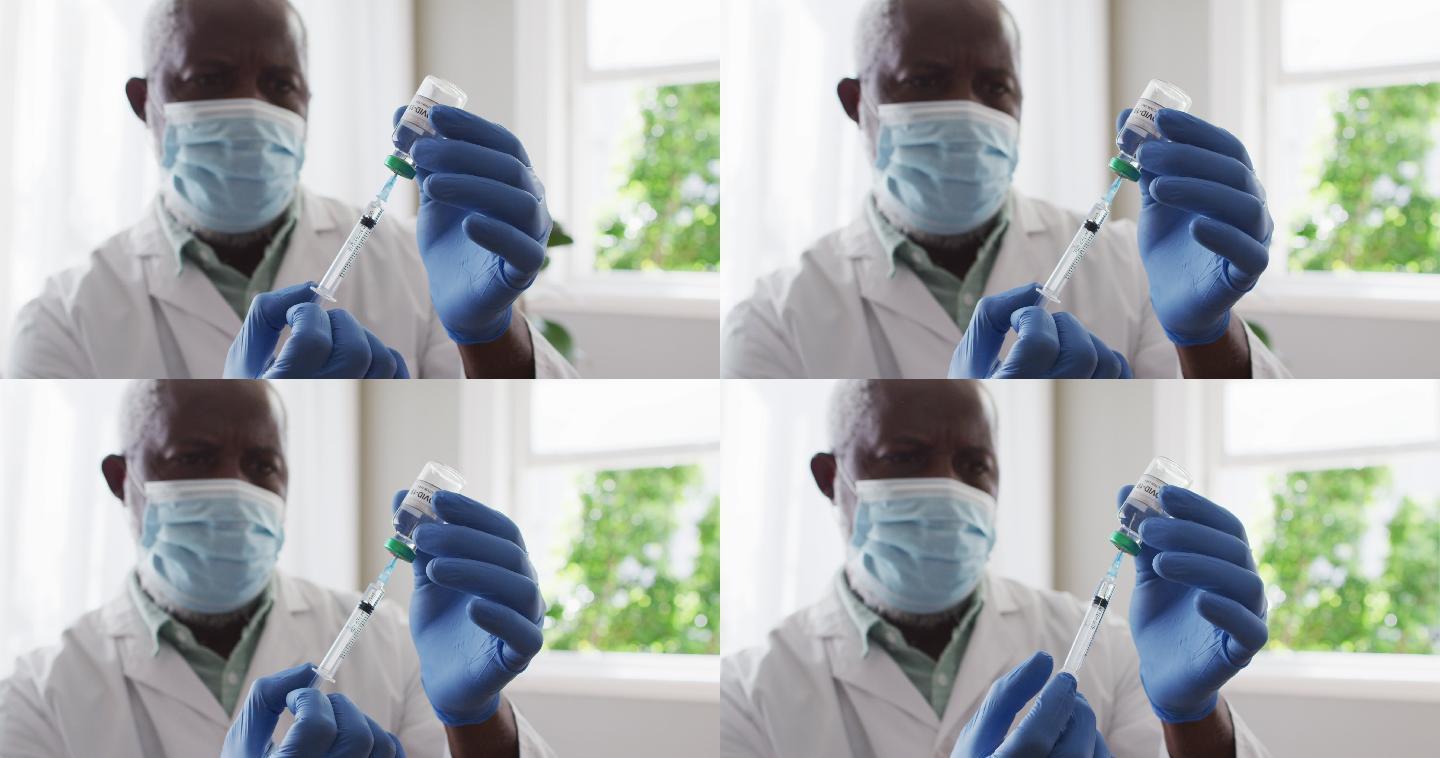 男非裔美国医生戴口罩，将covid-19疫苗放入注射器