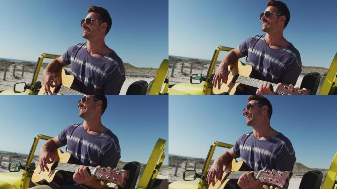 快乐的白人男子坐在沙滩车在海边玩吉它