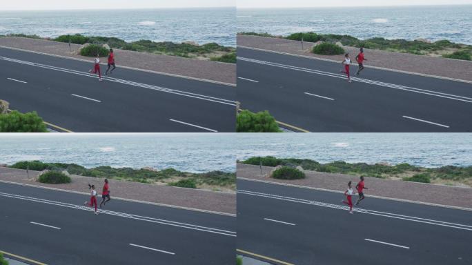 不同的健康夫妇锻炼跑步在一个山腰的乡村道路