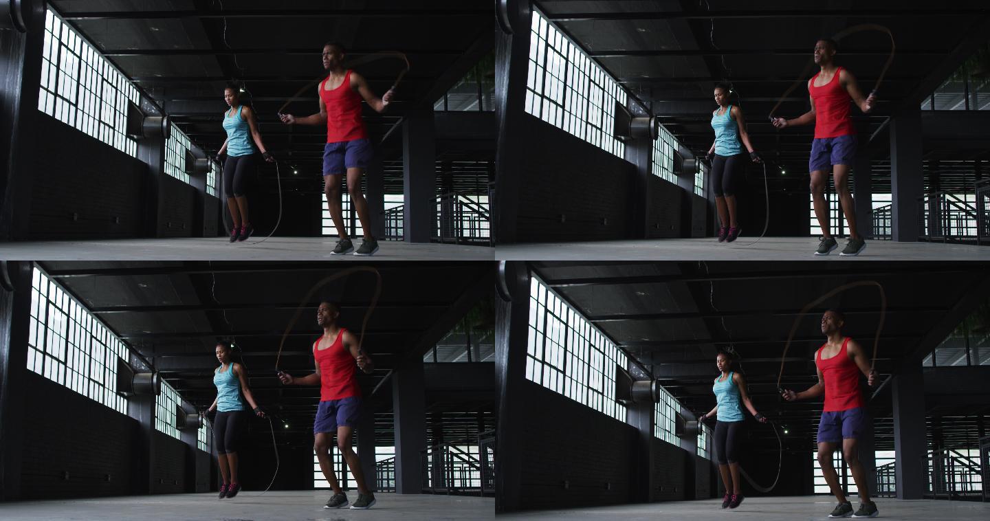 非裔美国男女在一座空的城市建筑里跳绳