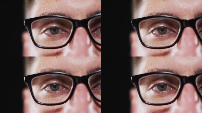 白人男子的脸部特写，戴眼镜，焦点在眼睛上