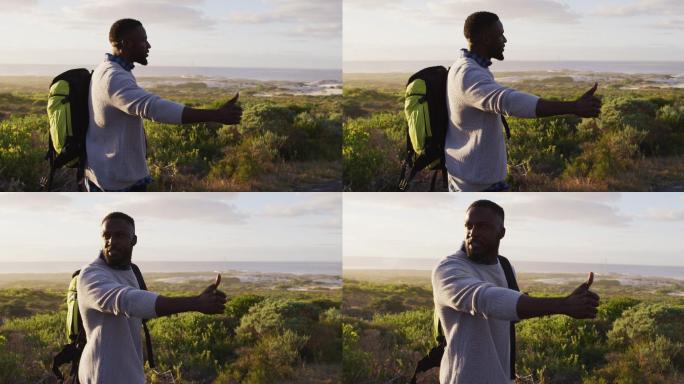 非裔美国人，背着背包，站在路上想搭车