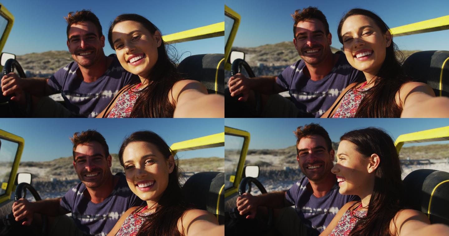 幸福的白人夫妇坐在沙滩车在海边用智能手机自拍