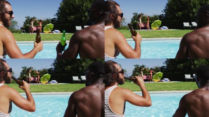 两个不同肤色的男性朋友坐在泳池边敬酒和喝啤酒