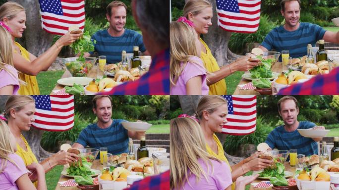 微笑的白人夫妇服务家庭一起在花园庆祝餐