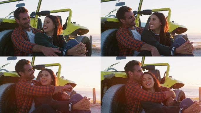 幸福的白人夫妇坐在沙滩车在海边聊天拥抱