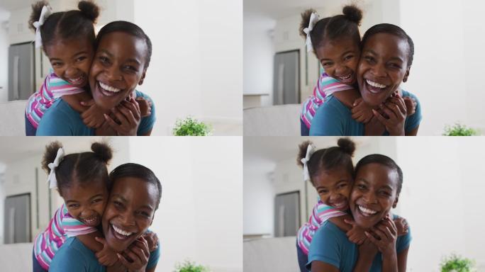 幸福的非裔美国母亲和女儿在家里拥抱的肖像