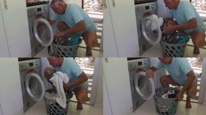 白人老人在家从洗衣机里脱衣服