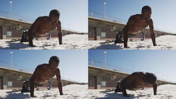 非裔美国人做俯卧撑，在海滩上做户外运动