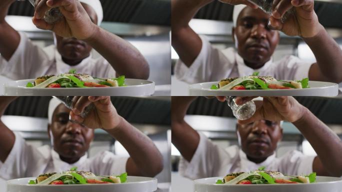 非裔美国男厨师在餐厅厨房里装饰菜肴