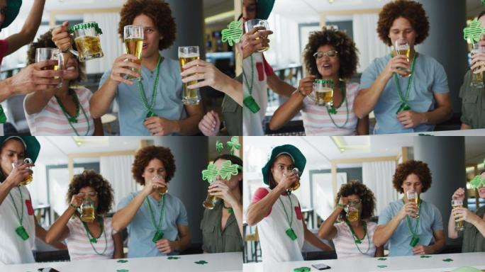 各式各样的快乐的朋友庆祝圣帕特里克节，在酒吧喝啤酒，祝酒