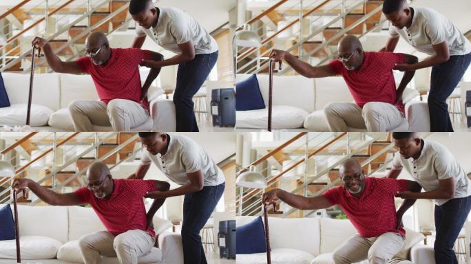 非裔美国老人用拐杖从沙发上爬起来，十几岁的儿子帮忙