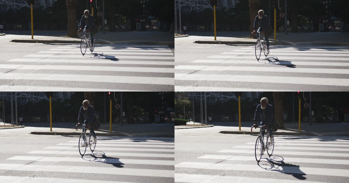 非裔美国老人骑着自行车过马路