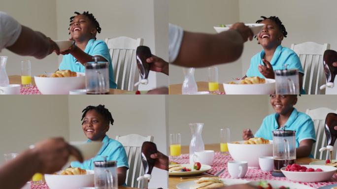 一个非洲裔美国男孩在家里和家人一起吃早餐时面带微笑