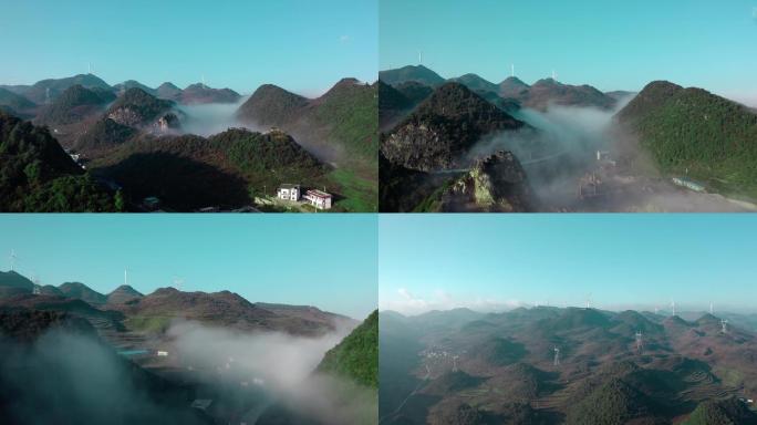 航拍贵州清晨薄雾中的喀斯特山间村庄和公路