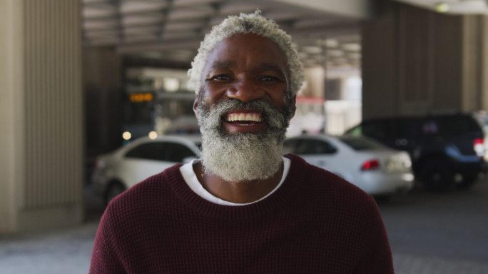 一幅非裔美国老人在停车场微笑的肖像