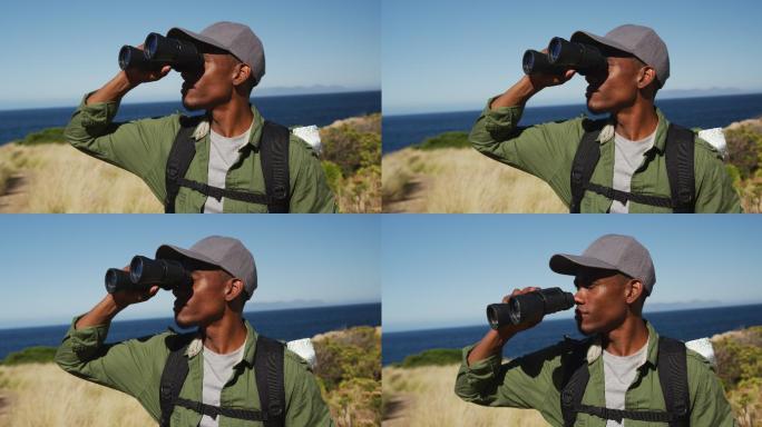 非裔美国人用望远镜沿海岸徒步旅行