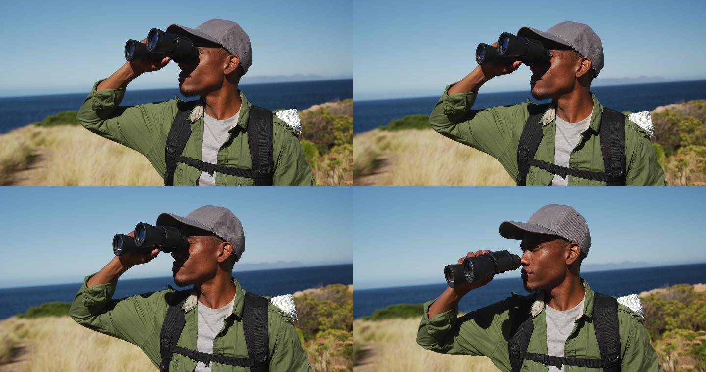 非裔美国人用望远镜沿海岸徒步旅行