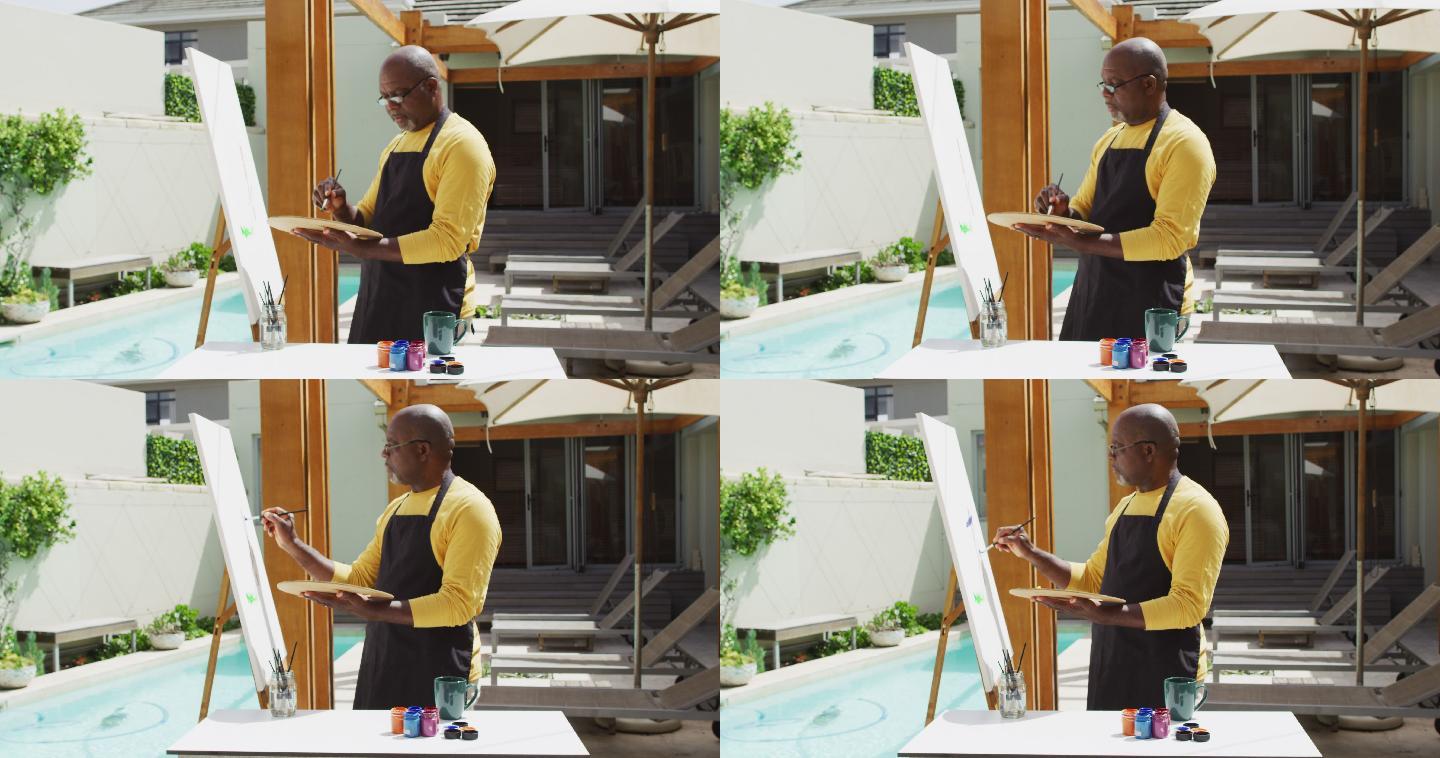 非裔美国老人站在阳台上画画
