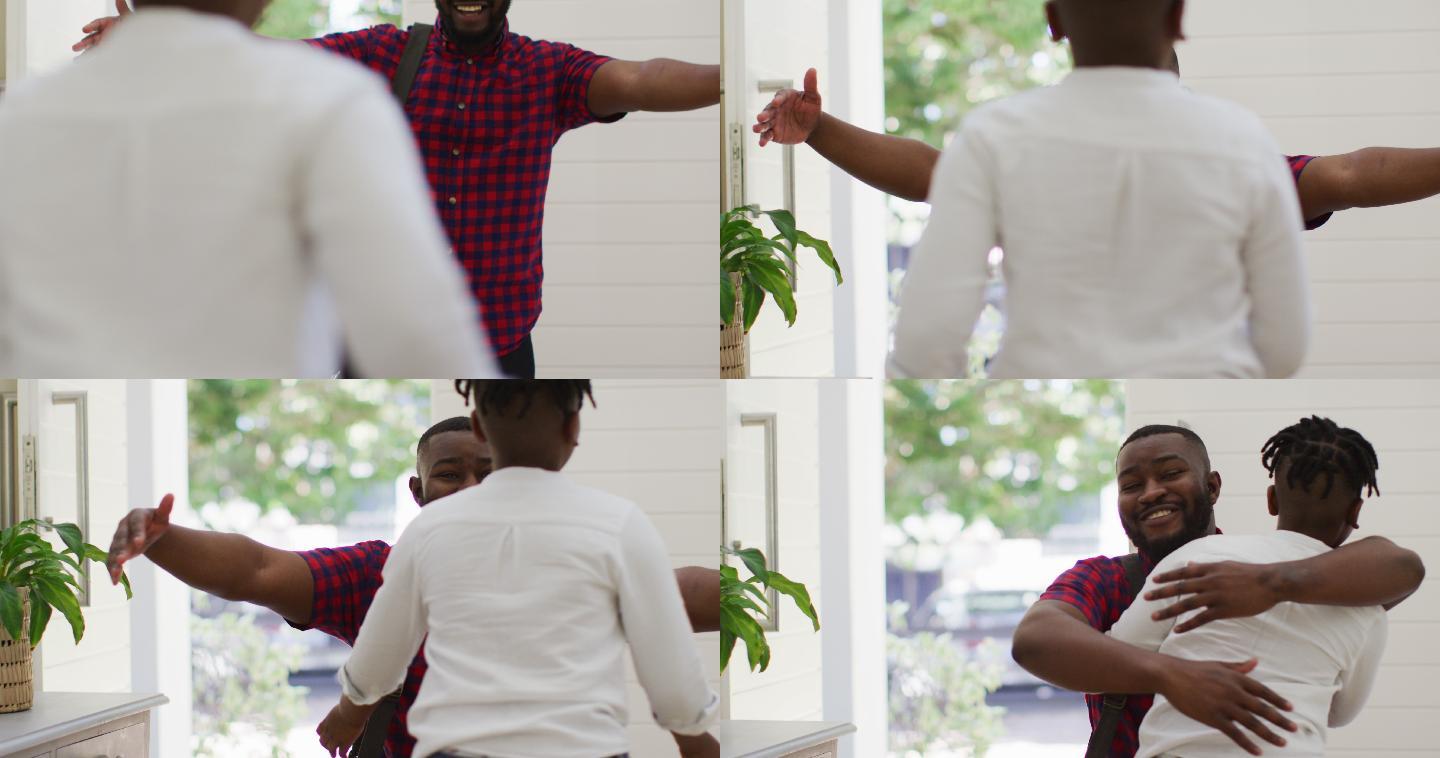 非洲裔美国人的儿子在前门跑着拥抱微笑着的父亲