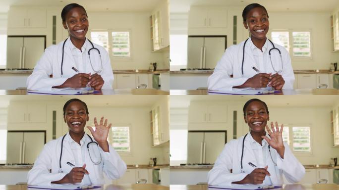 非洲裔快乐的美国女医生在视频电话咨询中挥手