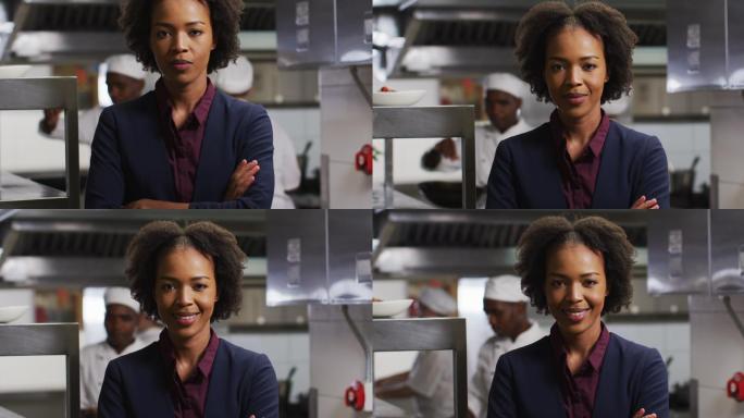 非裔美国女经理双臂交叉在餐厅厨房的肖像