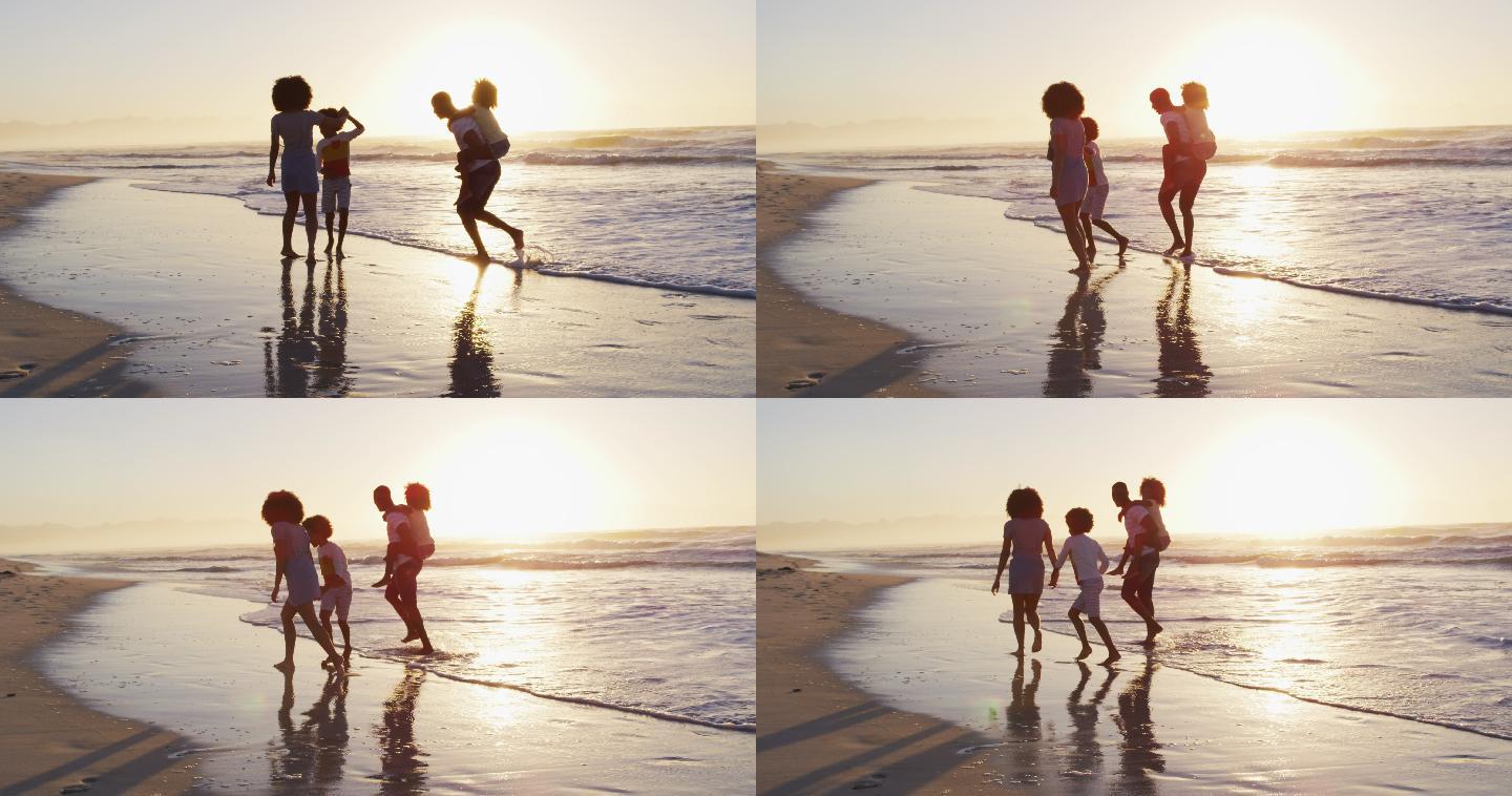 非裔美国家庭在日落时在海滩上一起玩乐