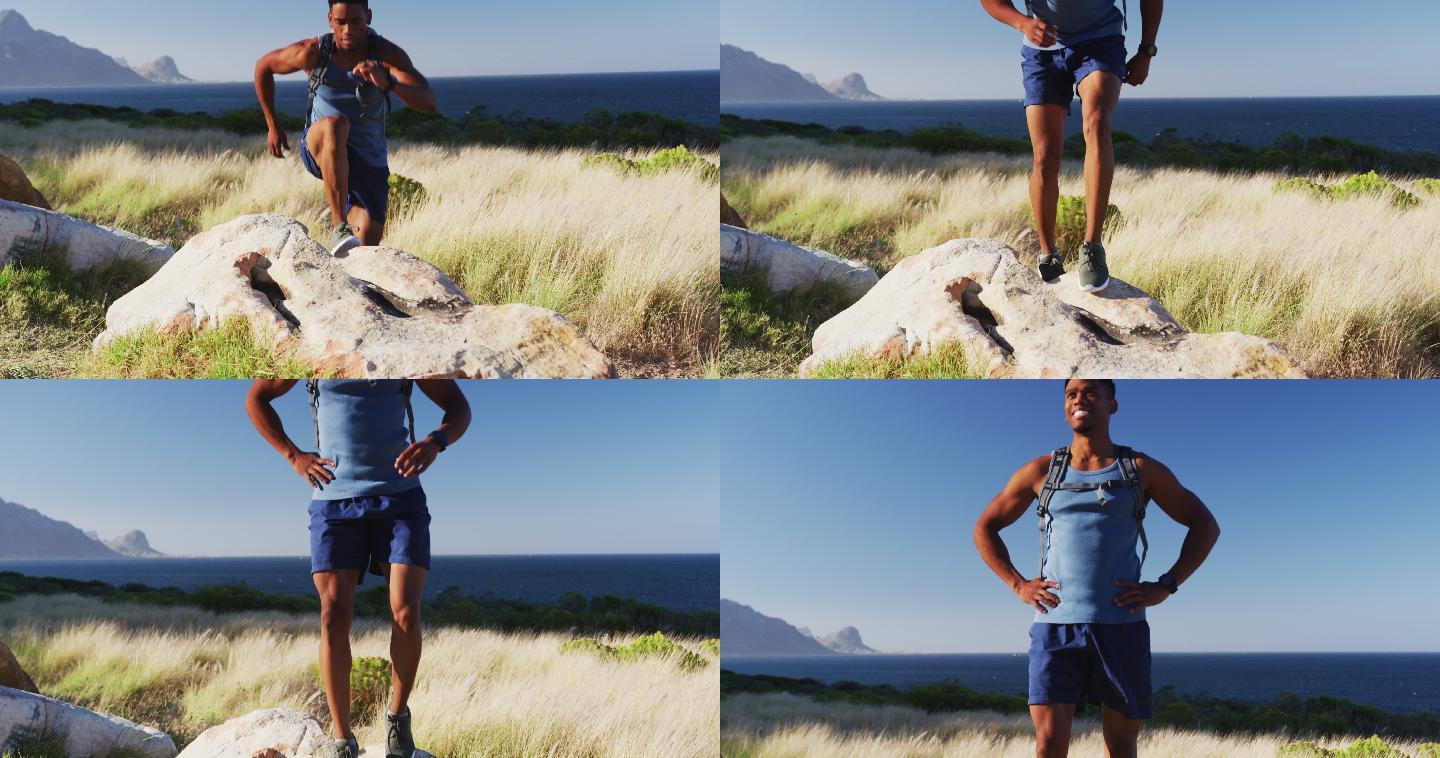 一个非裔美国人在户外运动，在乡间的岩石上跳在山上