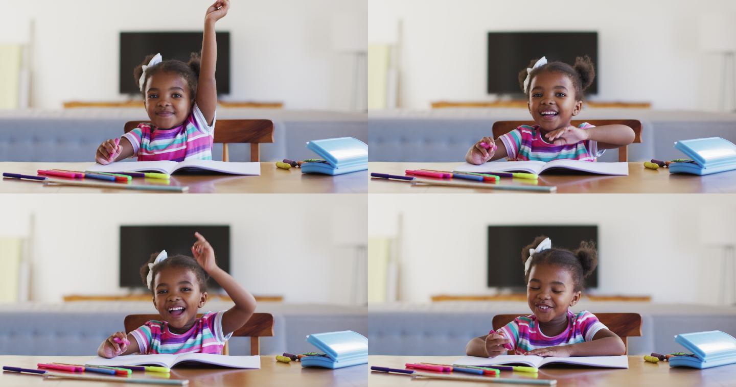 快乐的非洲裔美国女孩在网上学校在家里举手