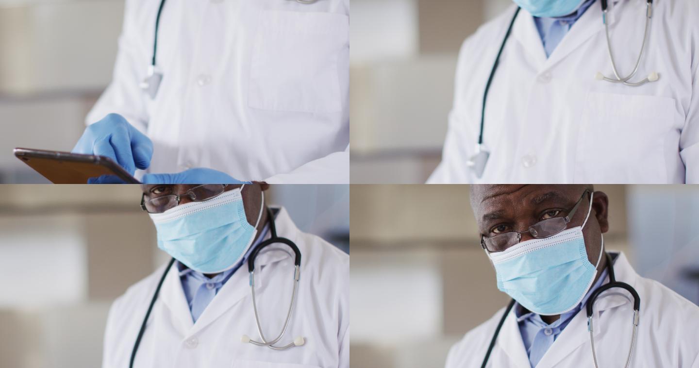 非裔美国资深男医生穿着白大褂使用数码平板电脑