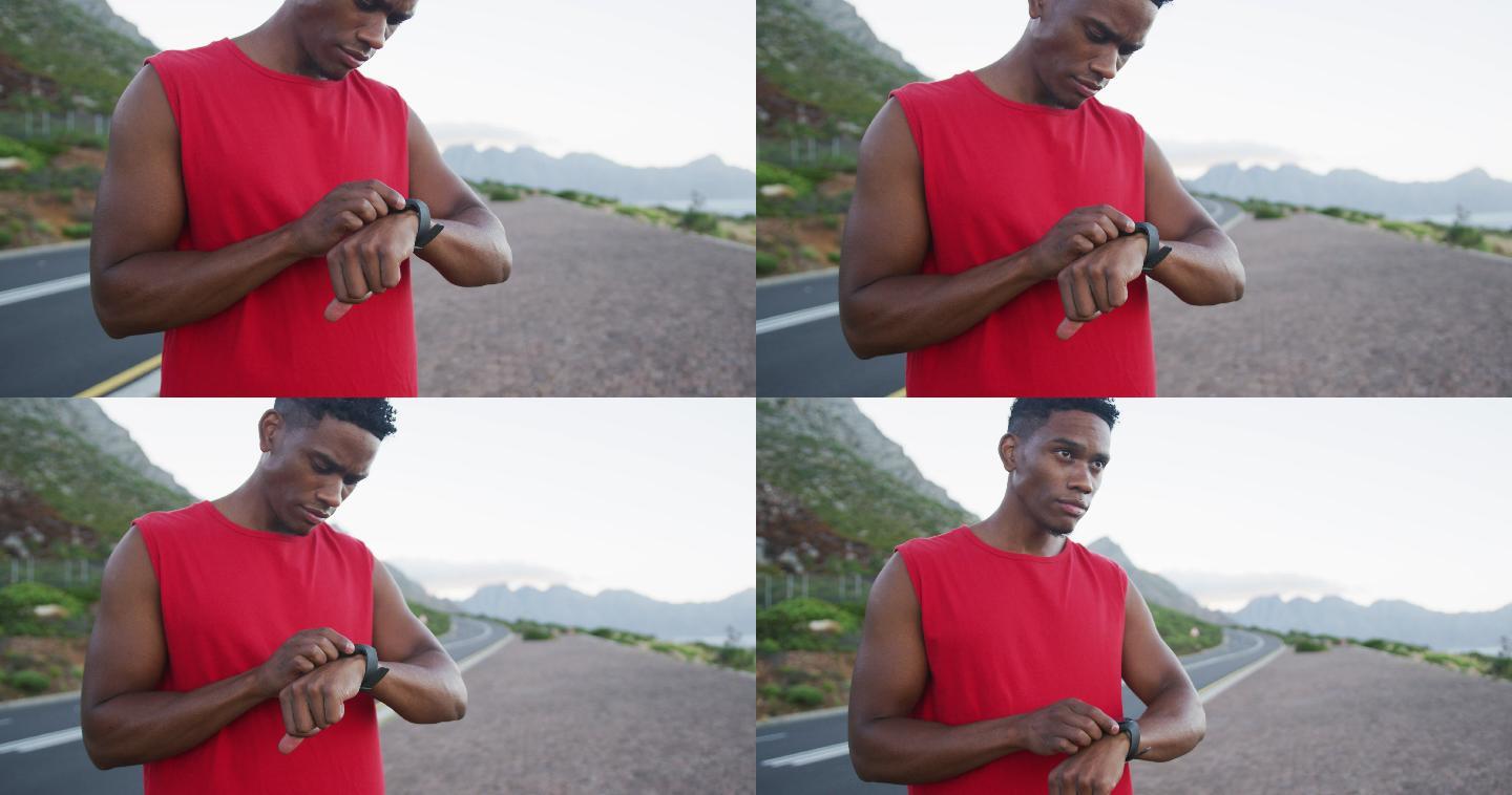 非裔美国人站在路上使用健身手环