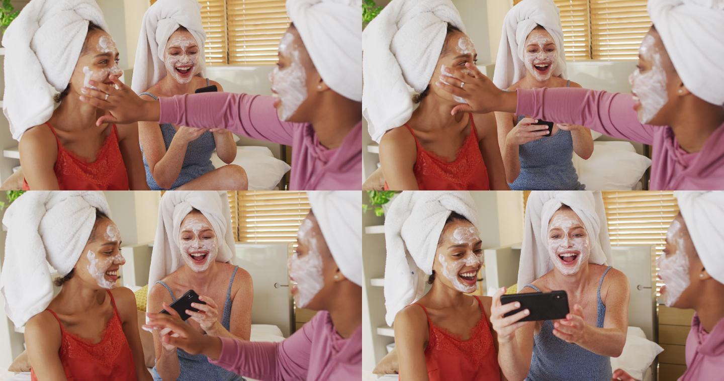 一群快乐的女性朋友戴着毛巾和清洁口罩在家自拍