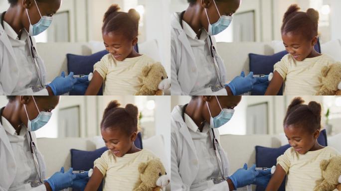 非裔美国女医生戴着口罩给家里微笑的女孩注射疫苗